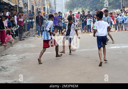 Les enfants portant un maillot en Argentine et en France jouent au football dans la rue lors du tournoi de la coupe du monde de la FIFA au Qatar, à Dhaka, au Bangladesh, sur 16 décembre 2022 Credit: Mamunur Rashid/Alamy Live News Banque D'Images