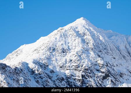 Quelques personnes au sommet du mont Snowdon, par une journée d'hiver ensoleillée et nuageux. Banque D'Images