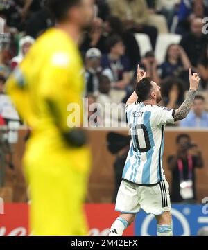 Lionel Messi (à droite), en Argentine, célèbre le premier but du match de son côté depuis la zone de la pénalité, alors que le gardien de but français Hugo Lloris semble abattu lors de la finale de la coupe du monde de la FIFA au stade Lusail, au Qatar. Date de la photo: Dimanche 18 décembre 2022. Banque D'Images