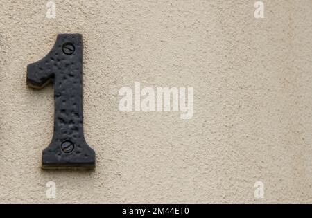 Le signe d'adresse numéro 1 sur un mur Banque D'Images