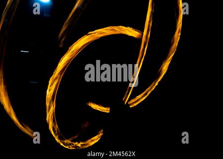 Lignes de feu chaotiques dans l'obscurité. Mouvement des flammes sur fond noir. Combustion de plasma. Banque D'Images