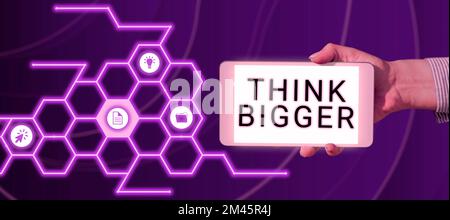 Écriture affichage du texte pensez plus grand. Aperçu de l'entreprise être capable de rêver et de visualiser ce que vous pouvez réaliser Banque D'Images