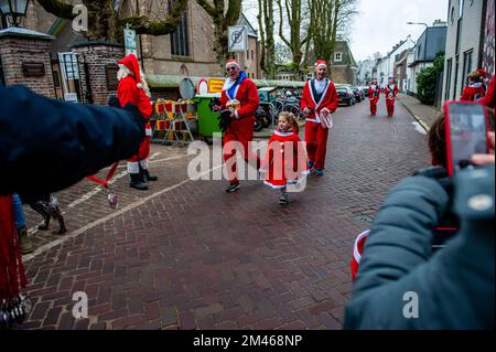 18 décembre, Breda. De nombreuses villes du monde entier accueillent de nos jours les événements du Santa Run. Dans la ville néerlandaise de Breda, deux cents personnes, dont des parents avec leurs enfants, ont couru en costumes du Père Noël à environ 3 km pendant la course du Père Noël. L'événement annuel était organisé par la fondation 'Rotary Santa Run'. L'événement a permis de recueillir au moins 8,000 € pour deux associations caritatives locales, la « Youth Breakfast Breda Foundation » et la fondation « Het Bonte Perdje », qui vise à offrir aux jeunes handicapés la possibilité de pratiquer des sports équestres en toute sécurité. Banque D'Images