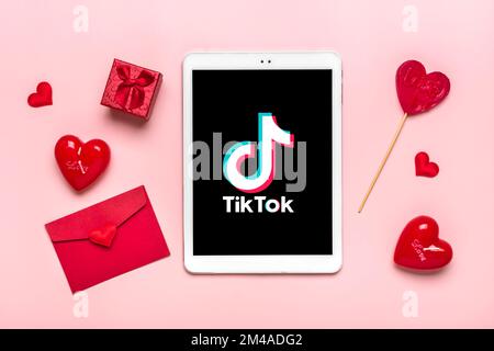 Bangkok, Thaïlande décembre 2022 smartphone Tik Tok icône de l'application, logo à l'écran, comme, deux coeurs rouges sur fond rose tendance des médias sociaux netwo Banque D'Images