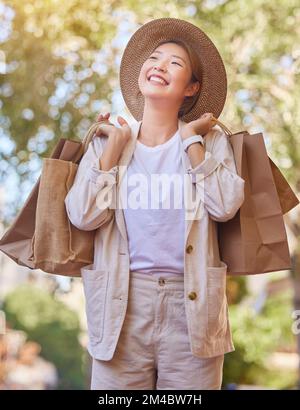 Épicerie shopping, Happy et femme dans la ville pour l'épicerie, penser à la vente et à la réduction de nourriture à Singapour. Souriez au détail, sac à provisions et asiatique Banque D'Images