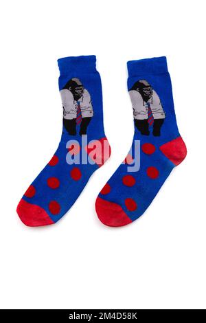 Chaussettes bleu Funy avec des singes et des points rouges sur eux isolés sur un fond blanc Banque D'Images