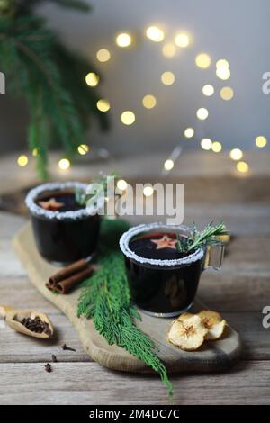 Vin rouge chaud chaud avec épices et fruits sur un fond rustique en bois. Décoration de Noël Banque D'Images