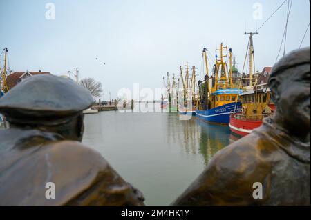 NEUHARLINGERSIEL, ALLEMAGNE - 26 NOVEMBRE 2022 : admirez la statue de bronze jusqu'au port Banque D'Images