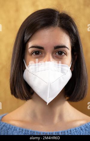 Portrait avant d'une fille brune avec FFP2 masques, concept de sécurité contre les virus et les agents pathogènes. La beauté dans le look Banque D'Images