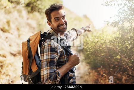 C'est ainsi. Portrait court d'un beau jeune homme qui montre le chemin tout en randonnée dans les montagnes. Banque D'Images