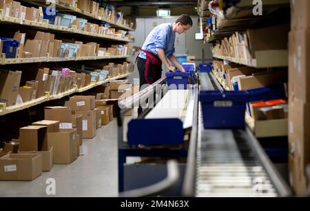 Planegg, Allemagne. 22nd décembre 2022. Un employé met une commande de médicaments au grossiste pharmaceutique Sanacorp. Sanacorp Pharmahandel GmbH est l'un des plus grands grossistes pharmaceutiques allemands. Les activités de l'entreprise sont axées sur la fourniture de produits pharmaceutiques et de soins de santé aux pharmacies. Credit: Sven Hoppe/dpa/Alay Live News Banque D'Images