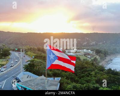 An aerial closeup shot of the Flag of Puerto Rico waving in the air at sunset Banque D'Images