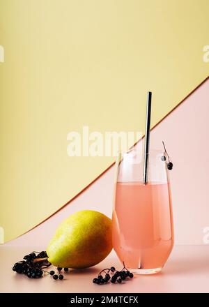 Boisson aux baies de sureau, cocktail avec poire sur fond coloré. Banque D'Images