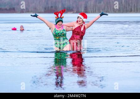 Les membres du groupe de nageurs sauvages du Loch Insh prennent part à une baignade sur le thème de Noël dans le Loch Insh, dans le parc national de Cairngorms, près d'Aviemore, en Écosse. Date de la photo: Vendredi 23 décembre 2022. Banque D'Images