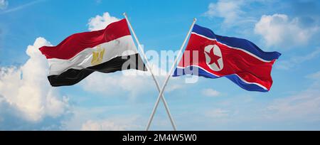 Deux drapeaux croisés la Corée du Nord et l'Égypte agitant sous le vent dans un ciel nuageux. Concept de relation, de dialogue, de voyage entre deux pays. 3d illustrati Banque D'Images