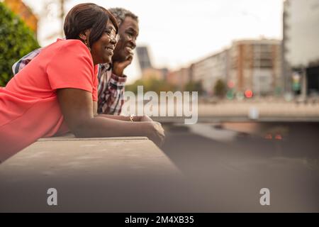 Un couple senior souriant s'est penché sur le mur Banque D'Images