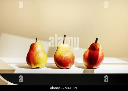 Un trio de poires par la lumière d'une fenêtre Banque D'Images