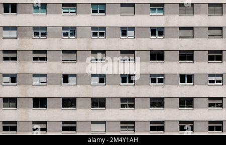 Façade de bâtiment dans des tons gris avec un motif géométrique de fenêtres avec volets. Concept d'architecture Banque D'Images