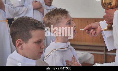 Pervomaysk, Bélarus - 17 juin 2022 : première communion catholique des enfants. Banque D'Images