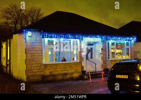 Les lumières de Noël sur le bungalow suburbain des années 1930 construit par john Lawrence aspirante classe moyenne sur la grande route de l'Ouest A82 Glasgow, Écosse, Royaume-Uni Banque D'Images