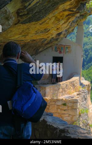 Photo verticale d'un photographe qui photographie des gens dans l'Hermitage de San Bartolomeo à Legio, en Italie Banque D'Images