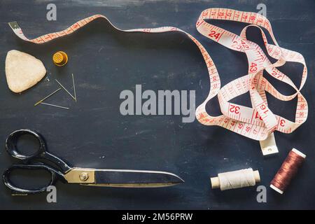 Set de tailleur. Ciseaux, aiguilles, mètre à ruban, tambour et craie Banque D'Images