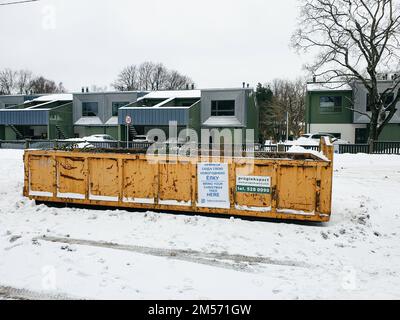 Tallinn, Estonie - 22 janvier 2022: Un grand conteneur à ordures dans une rue de la ville pour que les gens apportent leurs vieux arbres de Noël. Service municipal gratuit Banque D'Images