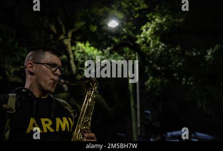 (Mobile, AL) — le Sgt Taylor Kosman, chef d’équipe de musique et joueur de saxophone, avec la bande de l’Armée 151st, joue en solo lors de la parade Mardi gras de l’ordre du LaShe, le 22nd février 2022. Mobile, lieu de naissance des Mardi gras américains, organise presque des défilés nocturnes pendant la saison des Mardi gras, la plupart des défilant attirant des foules de 10 000 personnes. Banque D'Images