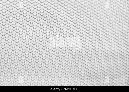 Grille de protection blanche en acier avec texture et motif de fond en mesh. Surface industrielle en fonte brute ondulée. Photo de haute qualité Banque D'Images