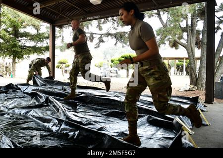 Une équipe en place de patient Decon (IPPD) du Groupe médical 8th se précipise pour assembler des systèmes d'abris de décontamination lors d'un événement de formation de routine à la base aérienne de Kunsan, République de Corée, 10 mars 2022. L'équipe de l'IPPD a assemblé un système d'abri de décontamination, pour décontaminer en toute sécurité les patients simulés avant des transférer à un établissement médical voisin pour traitement. Banque D'Images