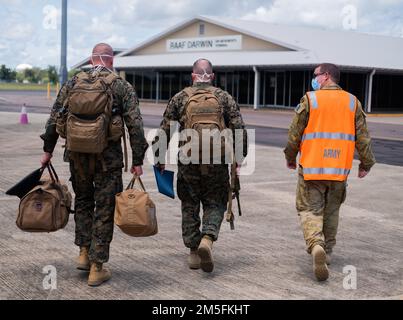 ÉTATS-UNIS Corps maritime Sgt. Major Justin Stokes, à gauche, Marine Rotational Force Darwin (MRF-D) 22 sergent major, et États-Unis Le colonel Christopher Steele du corps maritime, commandant du MRF-D 22, et un soldat australien traversent le tarmac en direction du terminal des mouvements aériens, base aérienne royale australienne Darwin, territoire du Nord, Australie, 14 mars 2022. Les Marines sont arrivées en Australie pour la onzième itération de la FRM-D, composée de Marines et de marins de I Marine Expeditionary Force, qui sera la première rotation dirigée par un élément de commandement régimentaire dédié. Banque D'Images