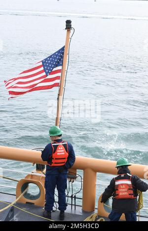ÉTATS-UNIS Garde côtière Petty Officer 2nd classe Nathan Sikes, un spécialiste culinaire à bord de la garde côtière Spar, se prépare à abaisser l'enseigne au fur et à mesure que le navire se met en route à Portland, Maine, 17 mars 2022. Spar et son équipage ont amarré à Portland tout en transitant de Baltimore à son nouveau homeport à Duluth, Minn Banque D'Images