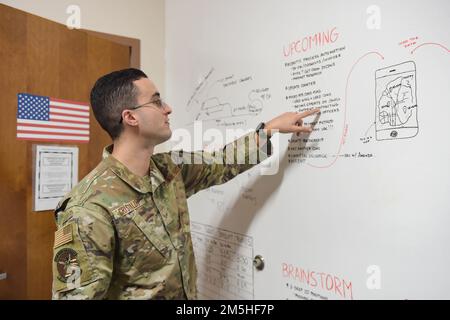 ÉTATS-UNIS Airman Lucas Christaldi, Senior de la Force aérienne, agent contractuel de la cellule innovation des affaires du 23rd Escadron, explique une partie des événements à venir pour la cellule innovation des affaires de la base aérienne Moody, en Géorgie, au 17 mars 2022. La mission de la cellule est de relier les partenaires de la mission et les industries commerciales, d’améliorer et d’automatiser les tâches de passation de marchés et d’être un épicentre de toutes les idées au sein de CONS 23rd. Banque D'Images