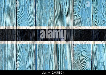 Drapeau du Botswana peint sur fond de planche de bois ancien. Texture de planche en bois à noeuds et lumière naturelle brossée. Texture en bois fond drapeau du Botswana. Banque D'Images
