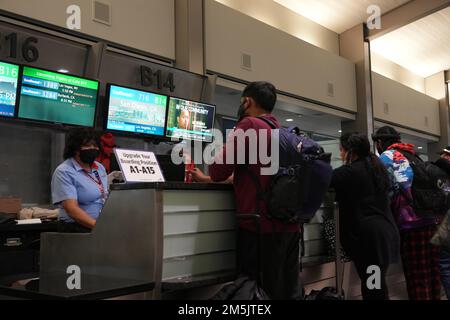 Les passagers attendent à un guichet de Southwest Airlines pour réserver à nouveau des vols retardés et annulés à l'aéroport international de Sacramento, le samedi 24 décembre 2022, à Sacramento. Banque D'Images