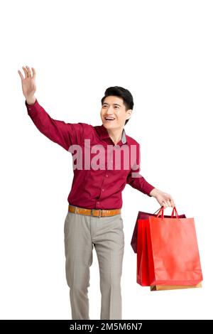 Remise sur un jeune homme portant un sac de shopping Banque D'Images