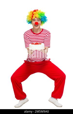Verser le clown amusant heureux, avec le gâteau Banque D'Images