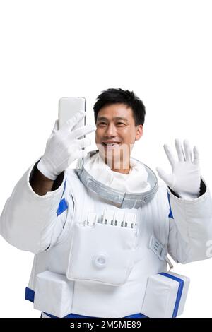 Les astronautes de l'abri affichent un téléphone portable Banque D'Images