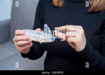 Femme prenant des médicaments de la boîte à pilules. Concept de soins de santé et de traitement Banque D'Images