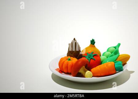 Le modèle alimentaire reste vivant avec des légumes colorés sur une assiette Banque D'Images