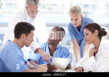Pas de place pour les erreurs dans les soins de santé. Un groupe de médecins ayant une discussion. Banque D'Images