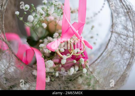 Deux anneaux de mariage dans un panier. Photo de haute qualité. Banque D'Images