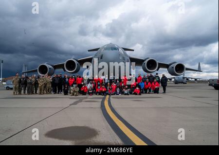 Les membres du Programme des jeunes de la Red-Twn Hawks posent pour une photo devant un C-17 Globemaster III lors de l'événement de l'aile inspiration et mentorat en aviation (AIM) à la base conjointe Lewis-McChord, Washington (16 avril 2022). L’escadre AIM est un programme de sensibilisation communautaire dont la mission est d’informer, d’influencer et d’inspirer la prochaine génération d’aviateurs de la Force aérienne. Banque D'Images