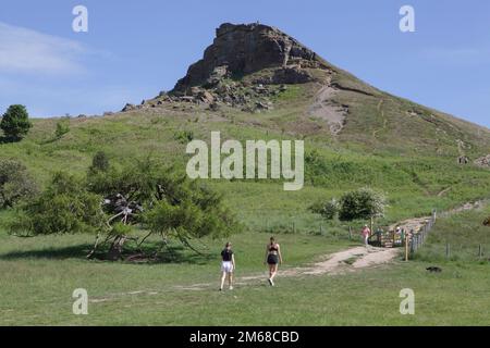 Les gens qui marchent à Roseberry Topping qui est un point de repère dans les Maures de North York lors d'une journée ensoleillée Banque D'Images