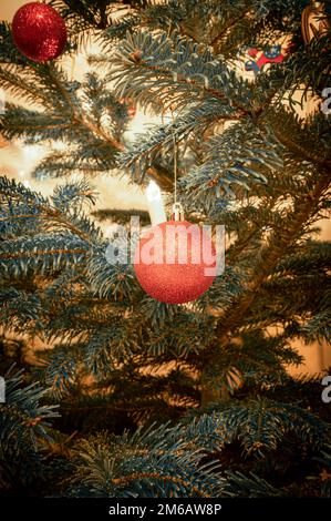 Un sapin de Noël rouge boule sur un arbre de Noël est l'éclairage d'arbre de Noël en arrière-plan, Hanovre, Basse-Saxe, Allemagne Banque D'Images