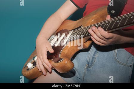 Adolescent apprenant à jouer de la guitare électrique. Gros plan. Banque D'Images