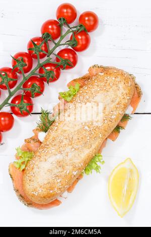 Rouleau de baguette de sandwich complet recouvert d'un portrait de saumon de poisson du dessus sur un panneau en bois Banque D'Images