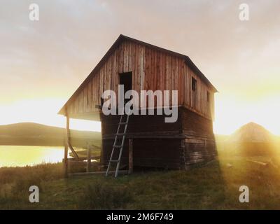 Ancienne maison en bois sur la rive du lac. Banque D'Images