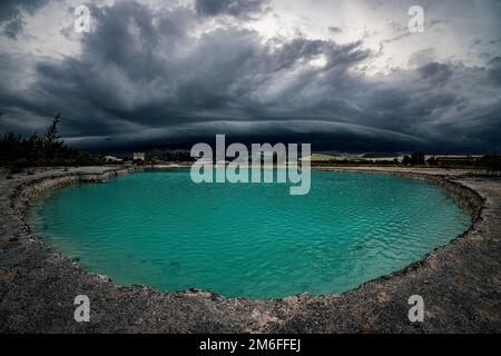 Les grands nuages noirs d'orage ou nuage d'Arcus, sont au-dessus de l'étang d'émeraude. Banque D'Images