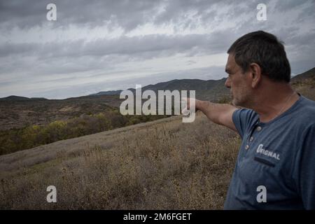 Giorgi Begiashvili (50) près du territoire occupé, me montrant un village ossète déjà occupé par les Russes. Comme Giorgi l'a mentionné à environ 100 mètres, il ya des Russes, contrôlant le territoire occupé et les clôtures barbelées qui sont déplacées à temps, il y a eu de nombreux cas lorsque les gardes russes ont enlevé des gens, comme les villageois sont effrayés vivant dans la zone de peur, à Mejvriskhevi, Géorgie sur 15 octobre 2022. 14 ans se sont écoulés depuis la deuxième invasion de la région de l'Ossétie du Sud en Géorgie. La deuxième fois que les forces militaires russes ont réussi à s'emparer du territoire, elle a commencé Banque D'Images